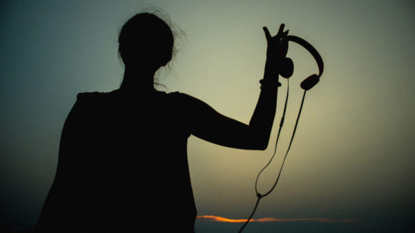 This image has an empty alt attribute; its file name is Woman-Silhouette-Headphones-Sun-1296x728-Header-1024x575-1-large.jpg